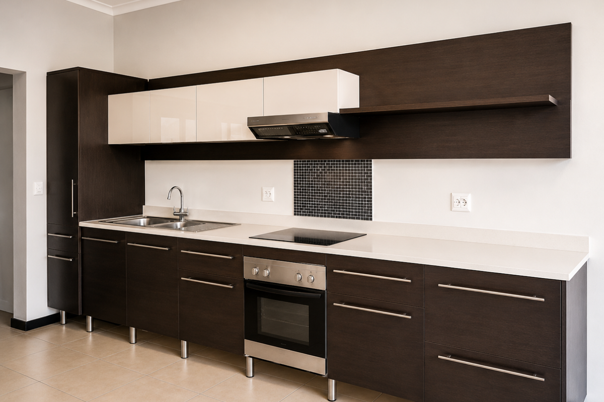 Modern kitchen featuring dark wood cabinetry, contrasting white upper cabinets, stone countertops, integrated stainless steel appliances, and a mosaic tile backsplash.