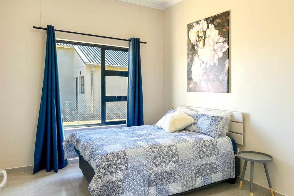 Spacious 2nd bedroom with built-in cupboards.