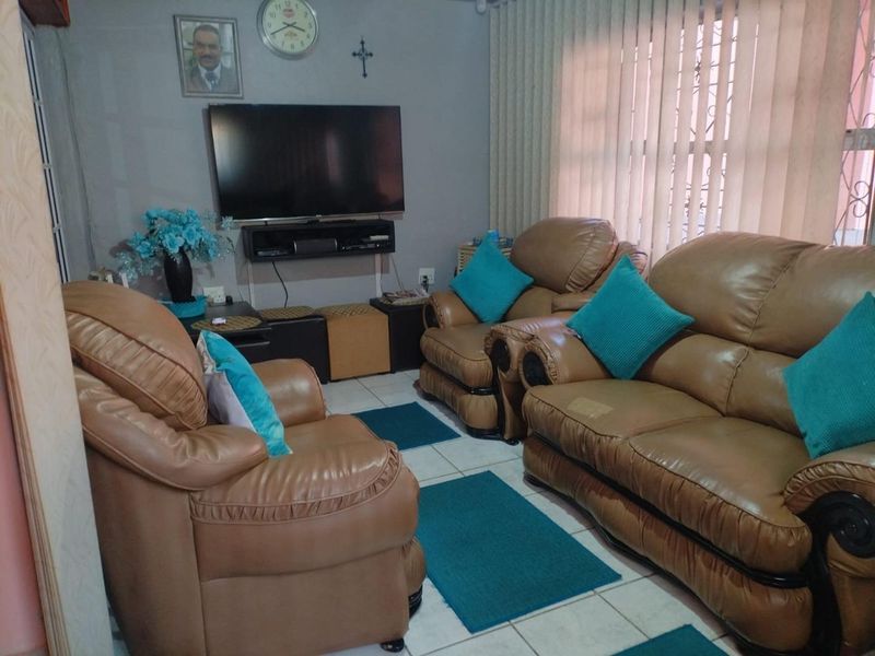 A living room featuring tiled flooring and vertical blinds, providing a functional space for relaxation.