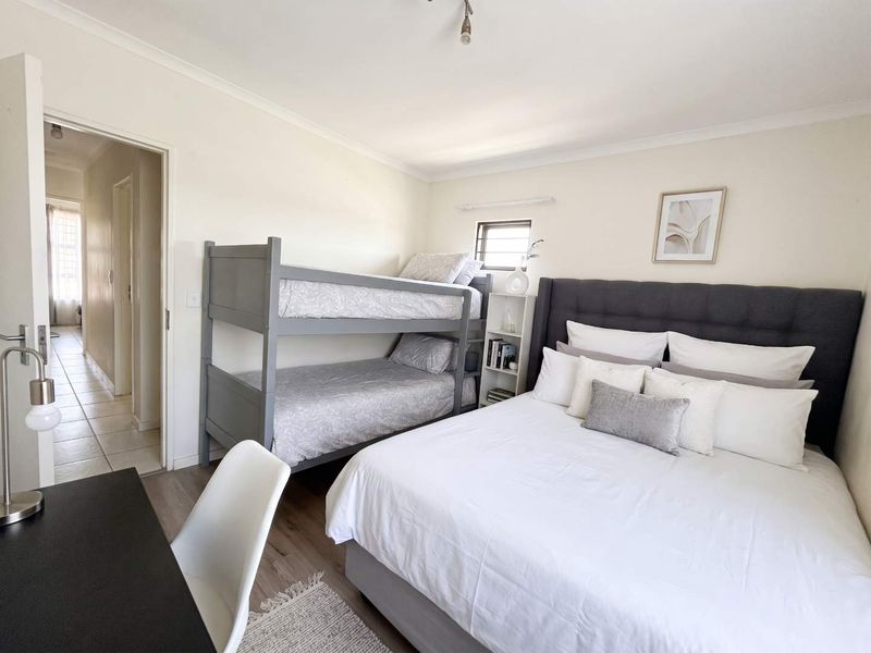 A well-maintained bedroom featuring neutral walls, coving, and a small window, providing a functional and comfortable living space.