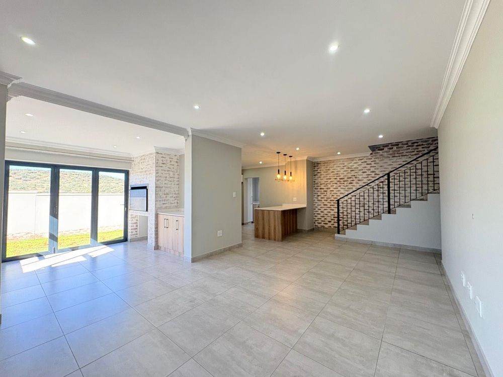 Open plan living, braai and dining area.