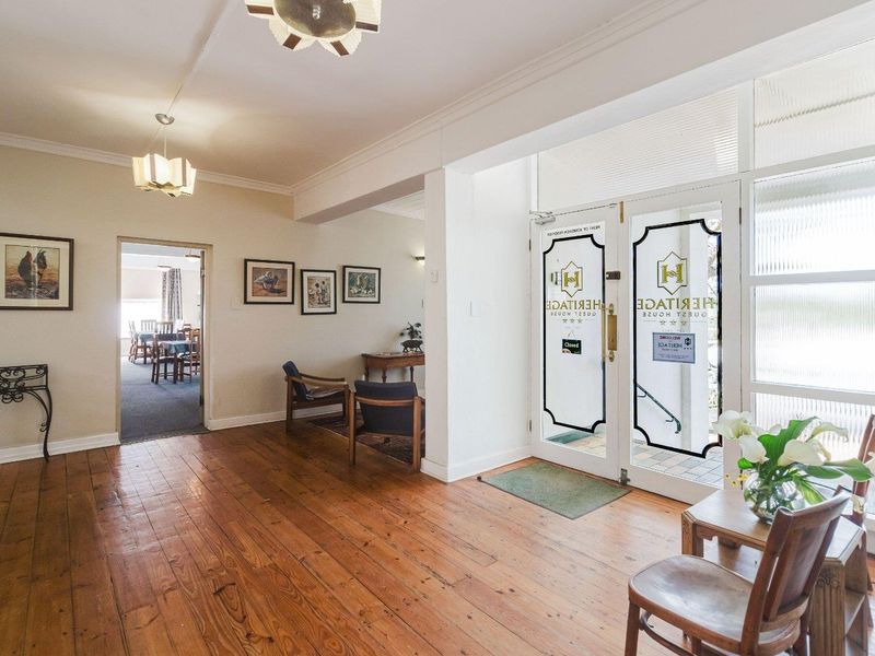 Welcoming entrance foyer featuring polished hardwood flooring, crown molding, and double glass doors leading to the exterior.