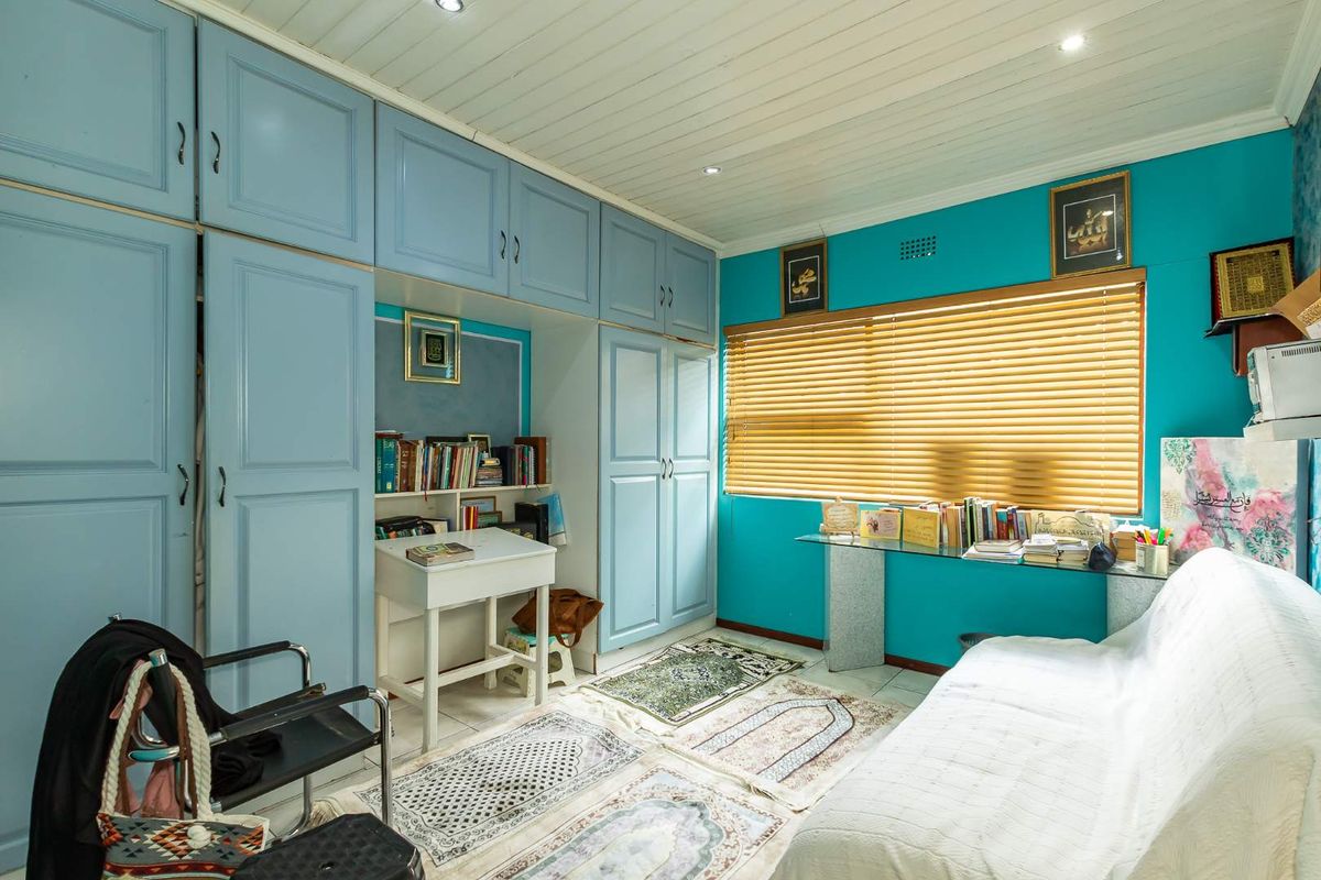 Bedroom featuring extensive built-in cabinetry, timber ceiling with recessed lighting, and venetian blinds.