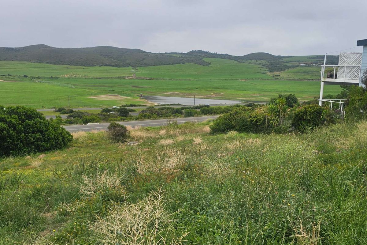 A view of the vacant residential land featuring natural vegetation with a scenic landscape and distant hills in the background.
