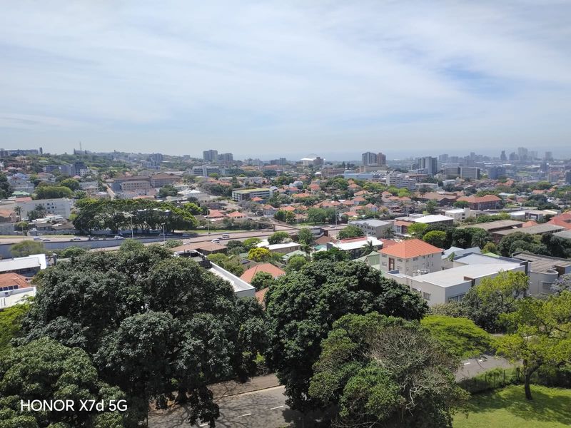 An elevated panoramic view overlooking the surrounding suburban landscape and city skyline.