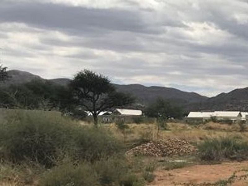 A scenic view of the surrounding landscape and mountain range, showcasing the natural terrain of the vacant residential land.