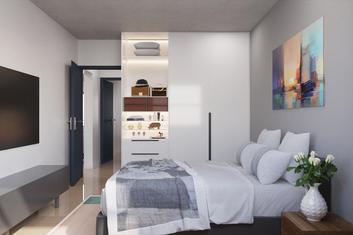 A modern bedroom featuring built-in floor-to-ceiling cabinetry with integrated shelving and lighting, clean finishes, and a neutral color palette.