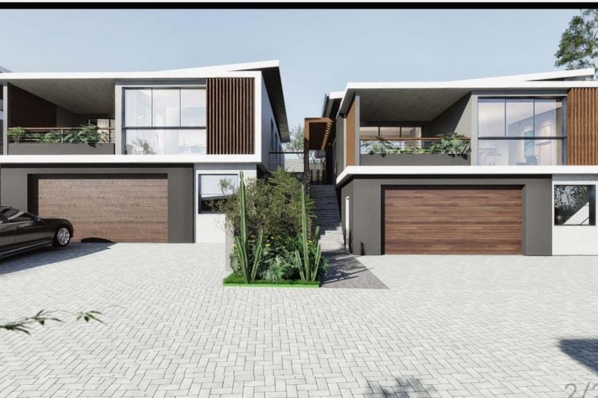 Modern double-story residential facade featuring timber accents, large glass windows, paved driveway, and integrated double garages.