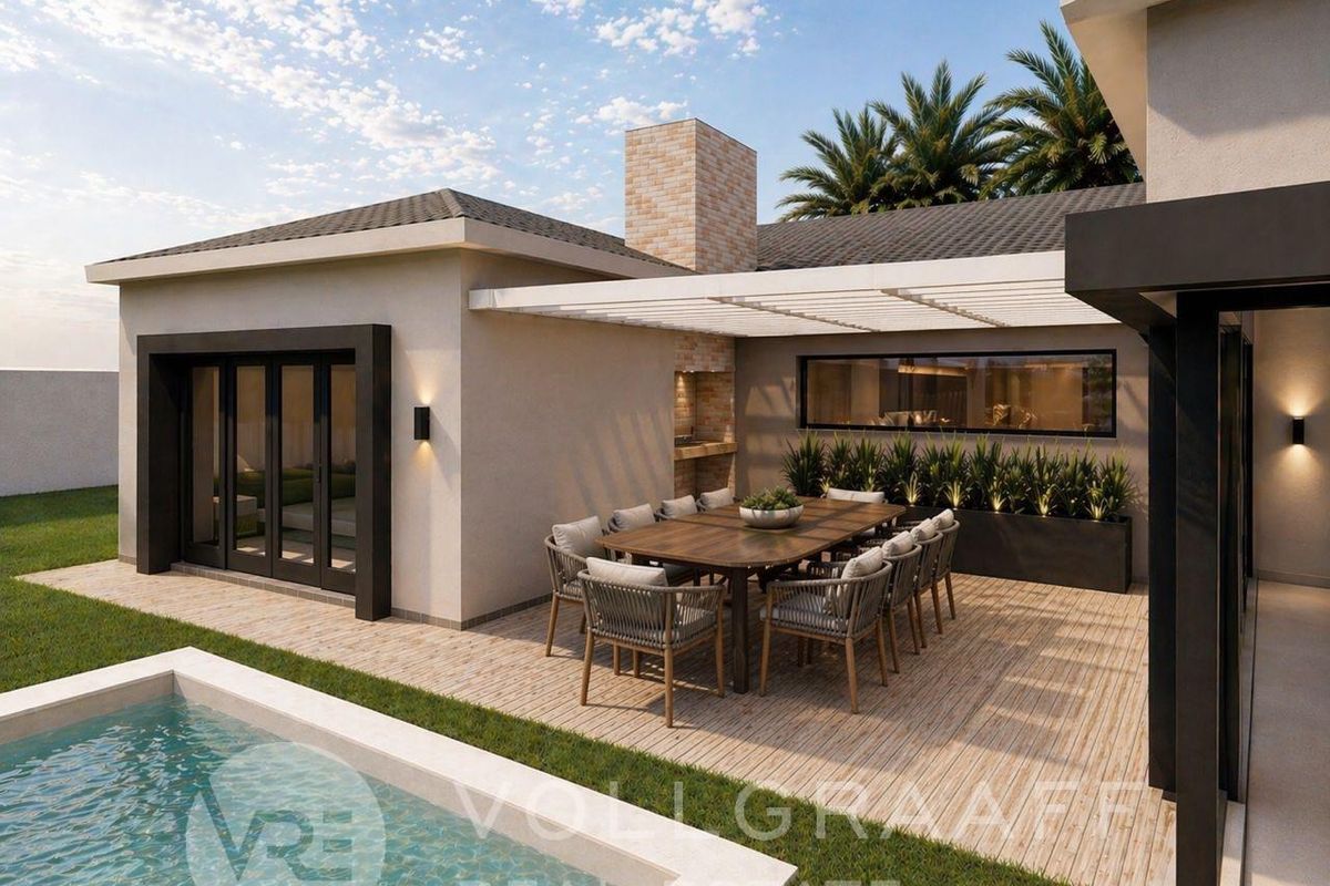 Modern outdoor patio area featuring a built-in braai, tiled flooring, and direct access to a swimming pool, perfect for alfresco dining and entertaining.