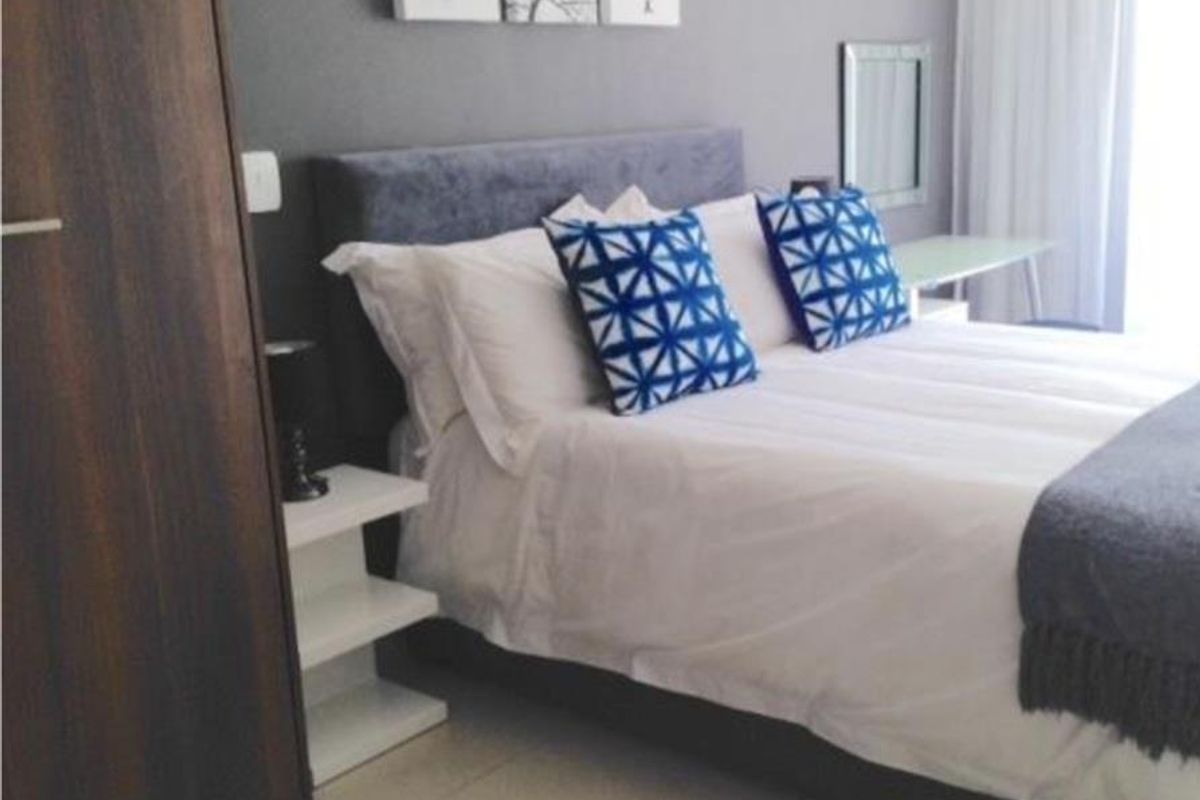 A well-maintained bedroom featuring tiled flooring and a built-in wardrobe, offering a clean and functional living space.