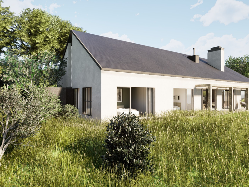 A modern residential property featuring a pitched roof, chimney, and a covered patio area with sliding glass doors, set within a natural landscape.