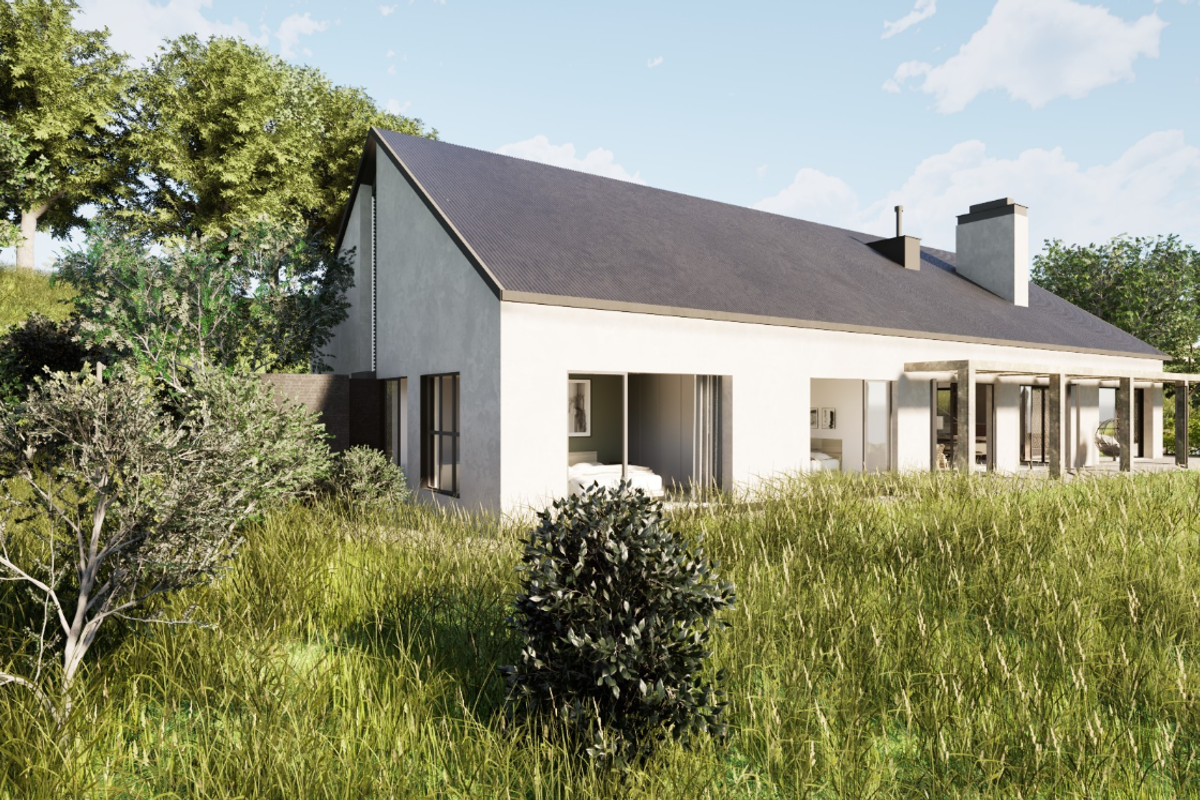 A modern residential property featuring a pitched roof, chimney, and a covered patio area with sliding glass doors, set within a natural landscape.