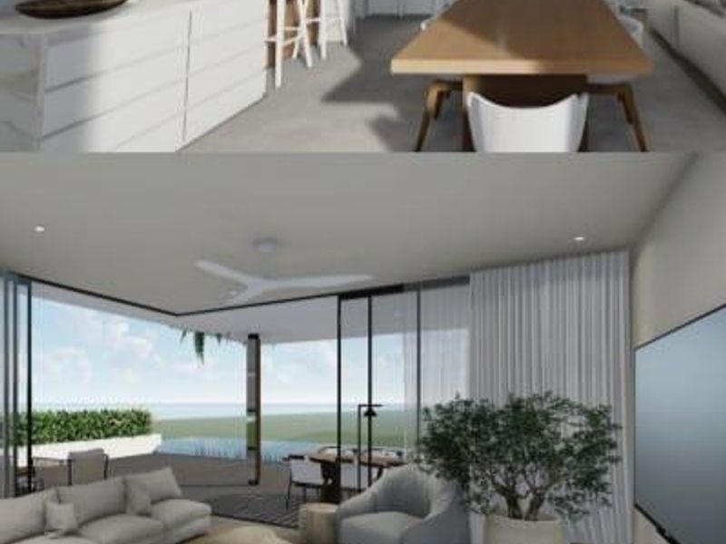 A modern open-plan living and kitchen area featuring sleek cabinetry, a large island, and expansive sliding doors opening to an outdoor space.
