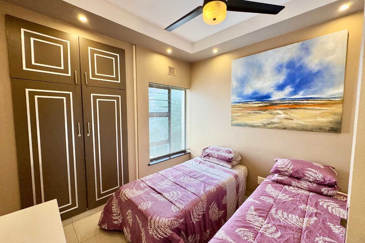 A well-maintained bedroom featuring built-in cabinetry, a ceiling fan, and recessed lighting, providing a functional and comfortable living space.