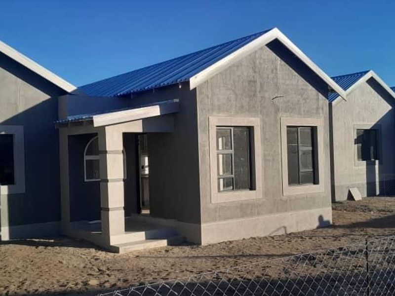 Front elevation of a modern residential house featuring a metal roof, plastered exterior walls, and a covered entrance porch.