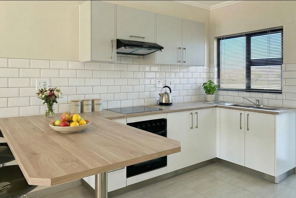 Kitchen with built-in cupboards & oven.