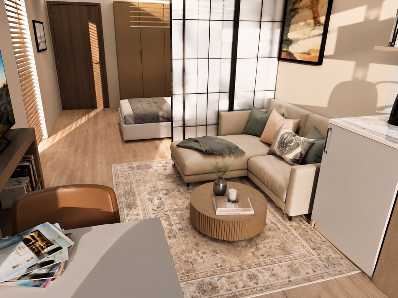 A modern open-plan studio apartment featuring light wood-tone flooring, built-in storage, and a functional layout with a designated living and sleeping area.