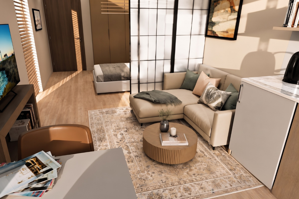 A modern open-plan studio apartment featuring light wood-tone flooring, built-in storage, and a functional layout with a designated living and sleeping area.