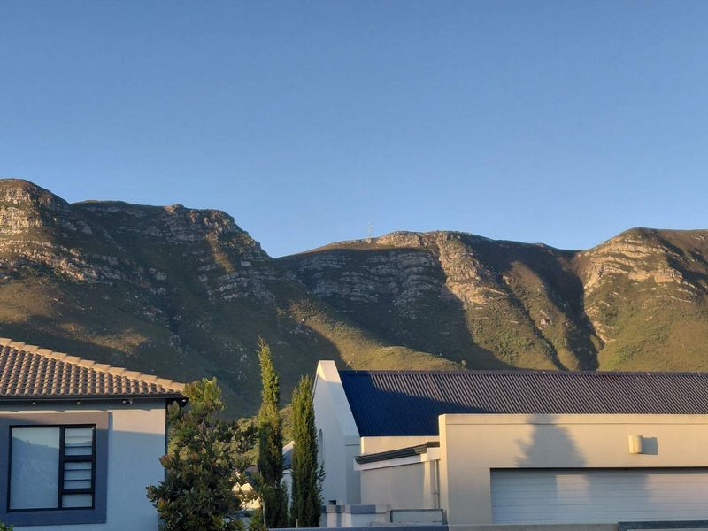 A scenic view of the mountain range overlooking the residential property.