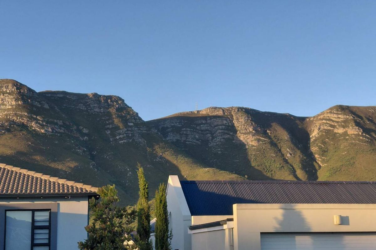 A scenic view of the mountain range overlooking the residential property.