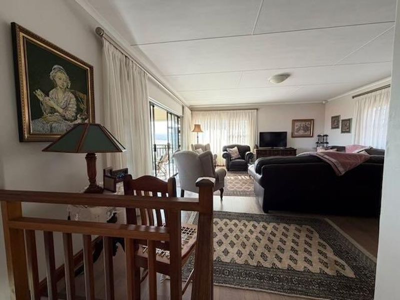 Spacious living room featuring laminate flooring and large sliding glass doors that provide access to an outdoor area.