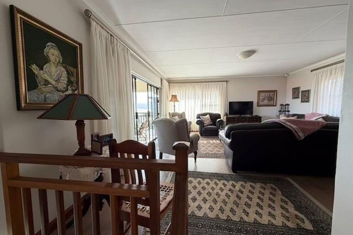 Spacious living room featuring laminate flooring and large sliding glass doors that provide access to an outdoor area.