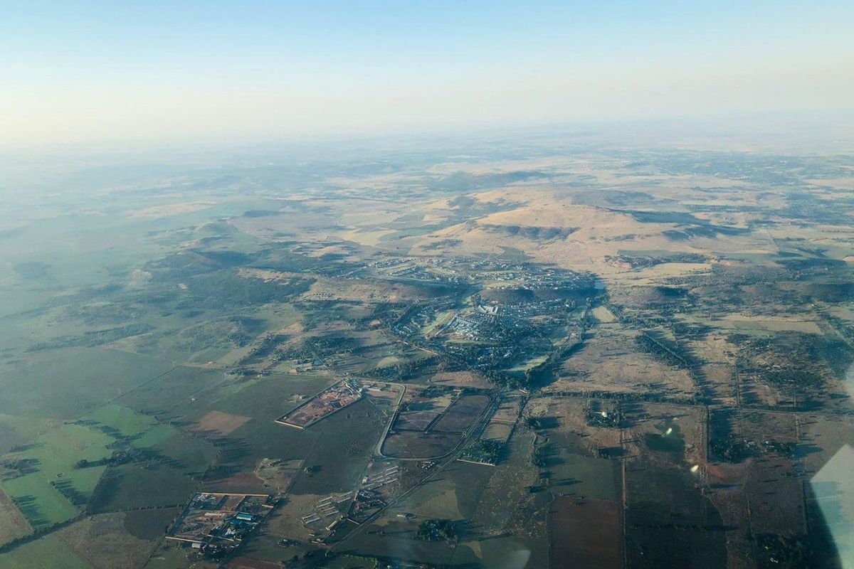 An aerial view showing the surrounding landscape and regional terrain from a high altitude.