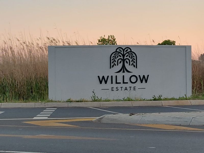 Entrance signage for Willow Estate, featuring a modern monument sign located at the roadside.
