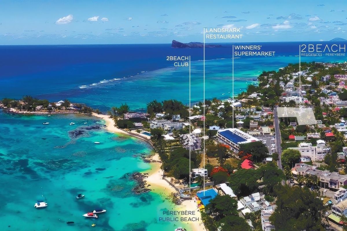 Aerial view of the coastal area surrounding 2Beach Residences in Pereybere, highlighting proximity to the public beach, local supermarket, and restaurant amenities.