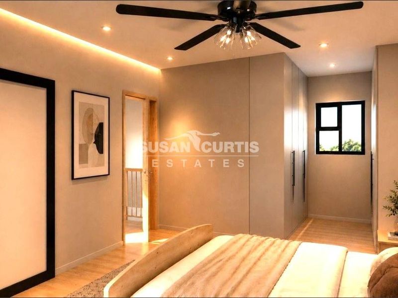 Modern bedroom featuring built-in wardrobes, recessed and cove lighting, a ceiling fan, and light-toned laminate flooring.