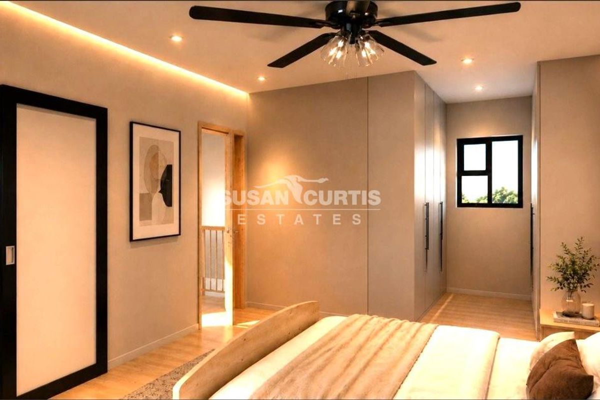 Modern bedroom featuring built-in wardrobes, recessed and cove lighting, a ceiling fan, and light-toned laminate flooring.