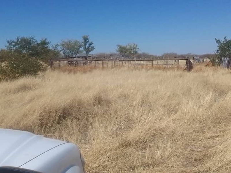 Expansive rural farm land featuring dry pasture and weathered wire fencing, suitable for agricultural use or development.