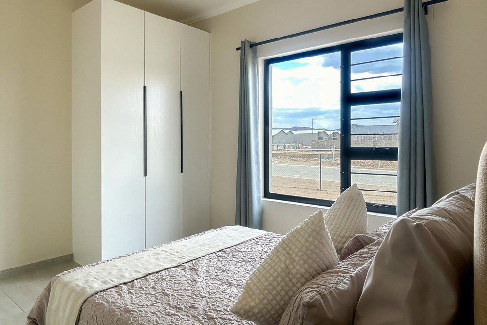 Second bedroom with built-in cupboards.
