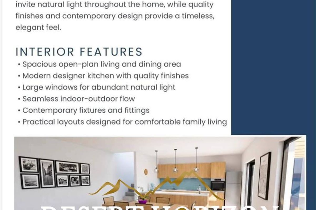 A modern open-plan living and kitchen area featuring contemporary cabinetry, pendant lighting, and large sliding doors providing seamless access to the outdoors.