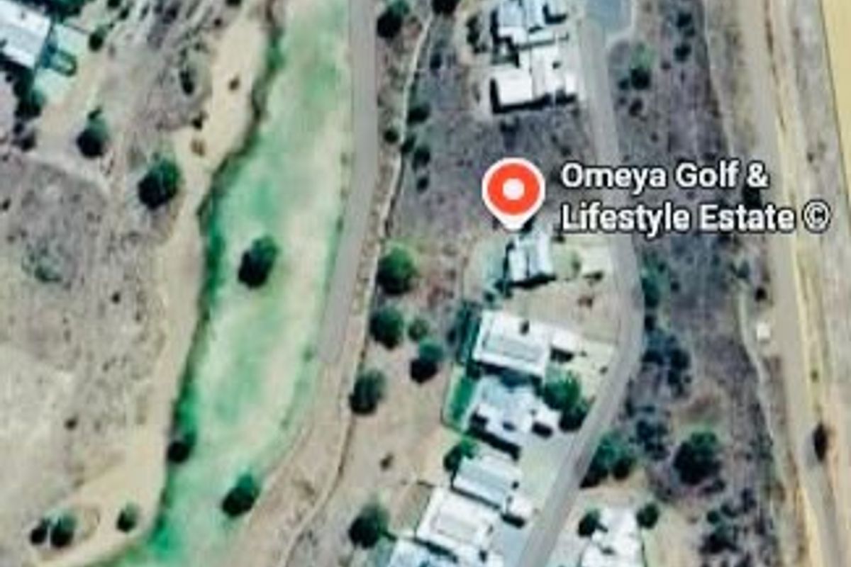 Aerial view of Omeya Golf and Lifestyle Estate showing the residential layout, golf course, and surrounding road infrastructure.