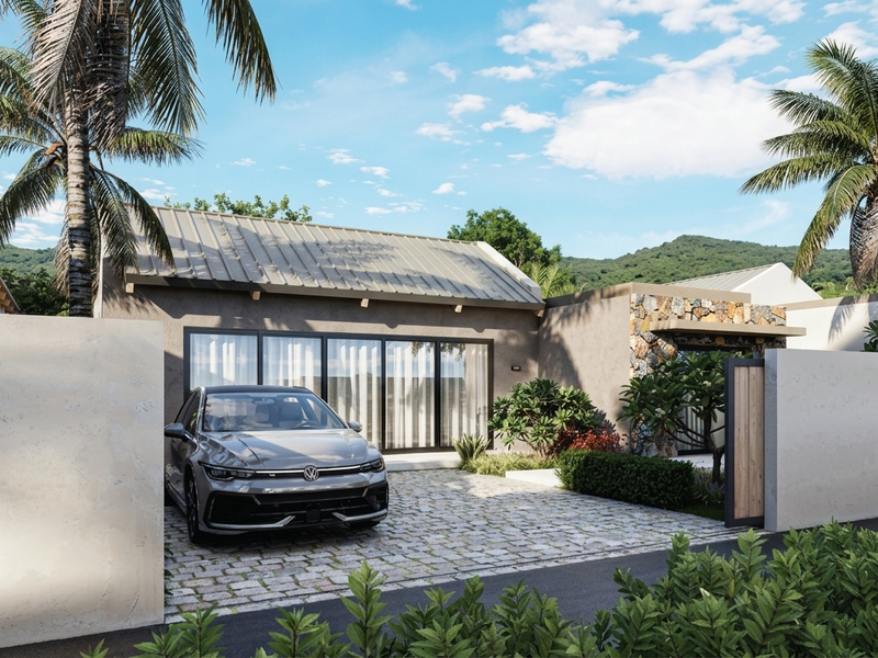 Modern single-story residence featuring a metal roof, stone-clad accents, and a private cobblestone driveway with secure perimeter walling.