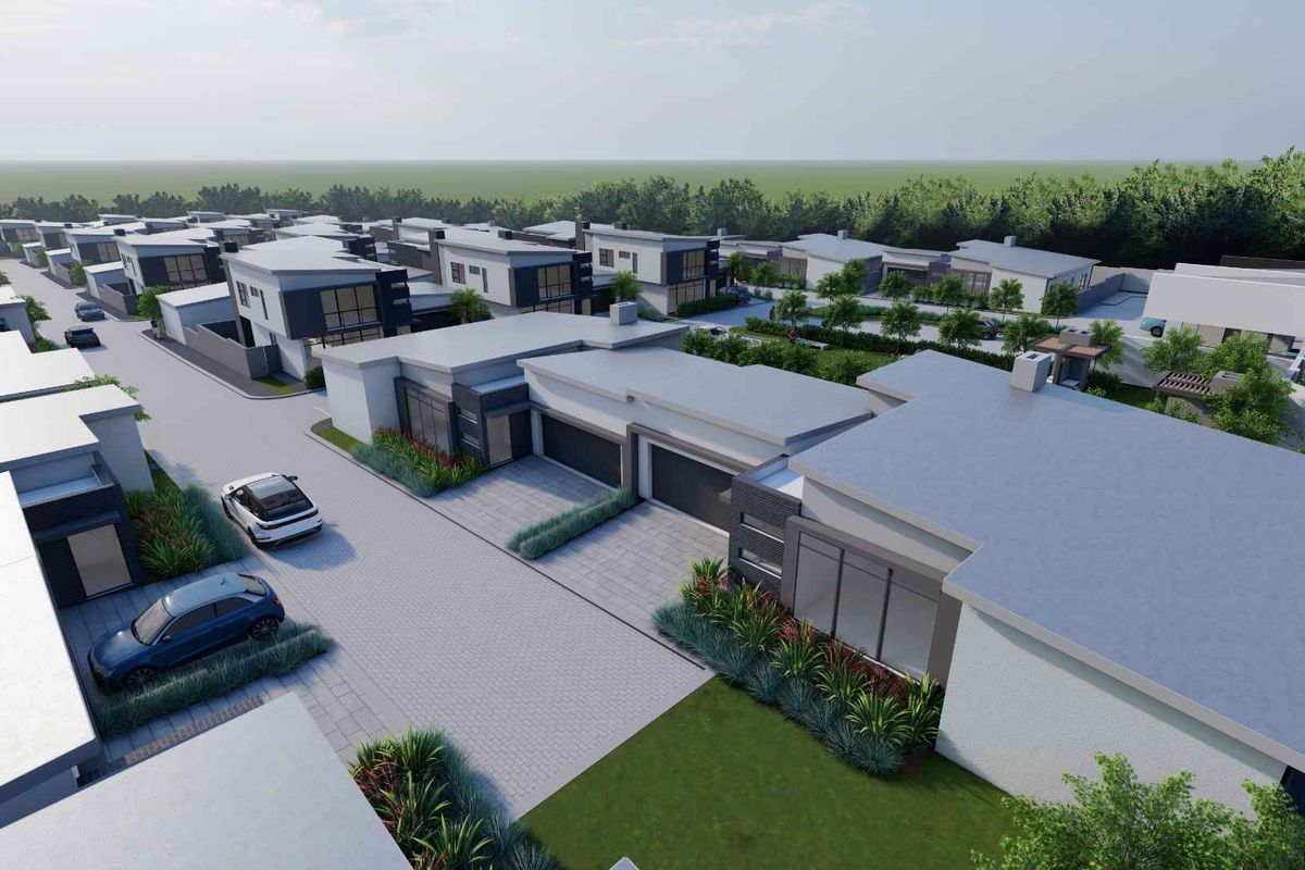 Aerial view of a modern townhouse development featuring paved driveways, integrated garages, and landscaped garden areas.