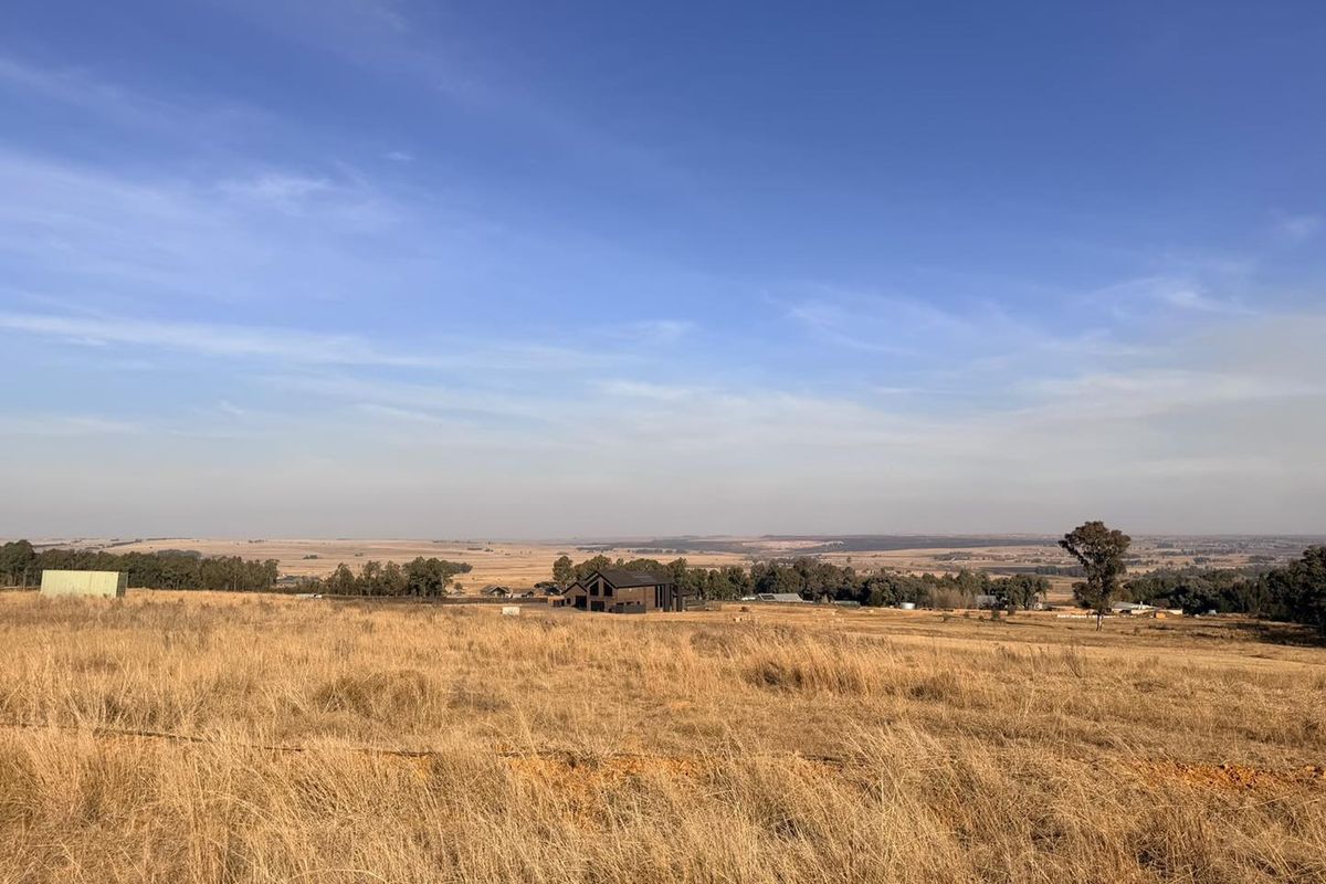 Expansive view of the surrounding rural landscape and open fields, showcasing the natural terrain and distant horizon.