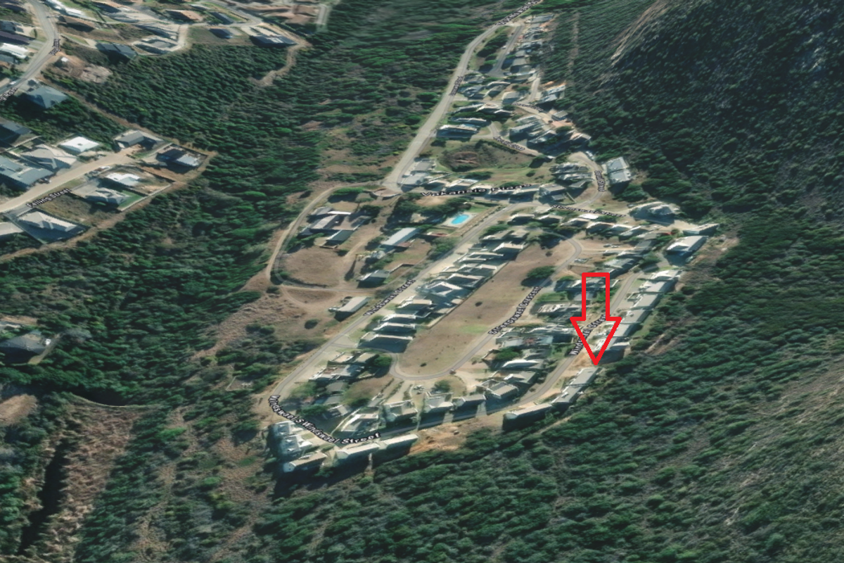 Aerial view of a residential neighborhood showing the location of the vacant land plot within the established street layout.