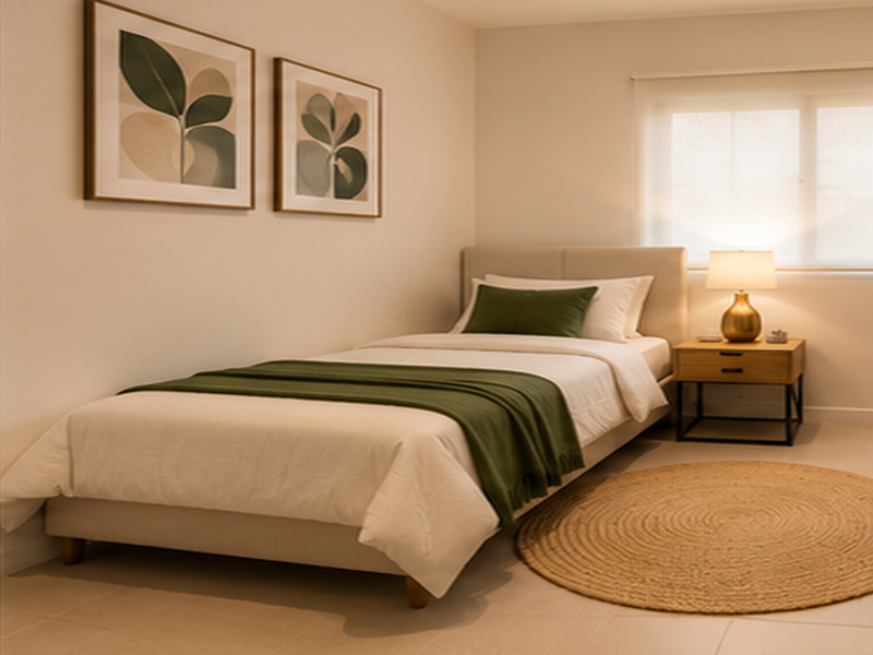 A well-lit, neutrally decorated bedroom featuring tiled flooring and a roller blind, creating a comfortable and inviting living space.
