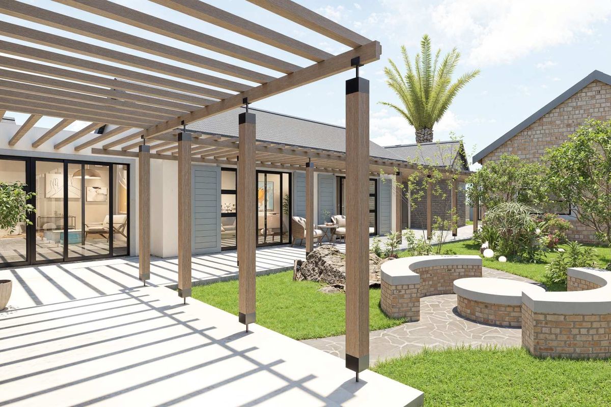 A beautifully landscaped rear garden featuring a modern timber pergola, paved patio area, and a curved brick seating feature.
