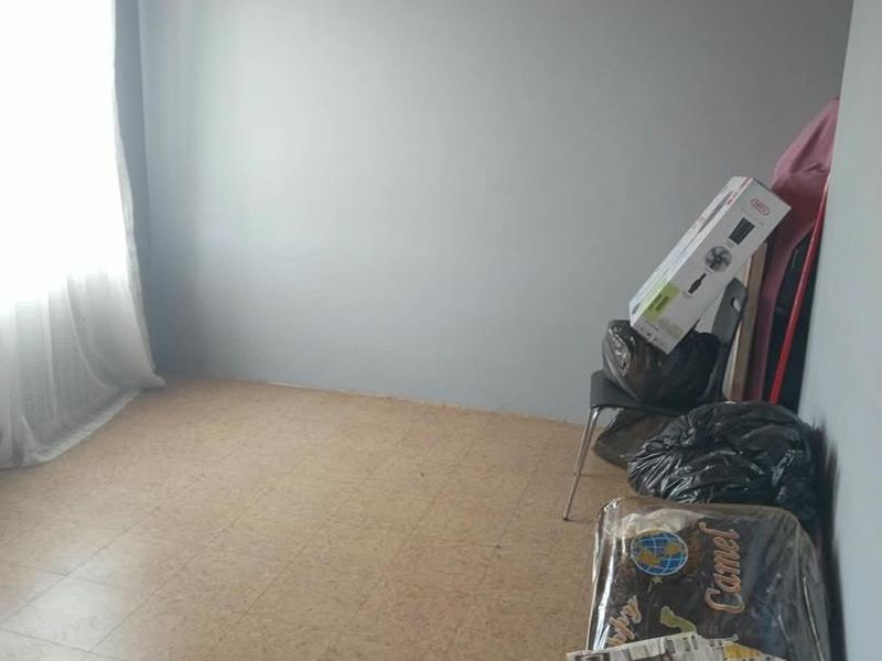 A bedroom featuring a timber-clad ceiling and tiled flooring, offering a blank canvas for potential renovation and modernization.