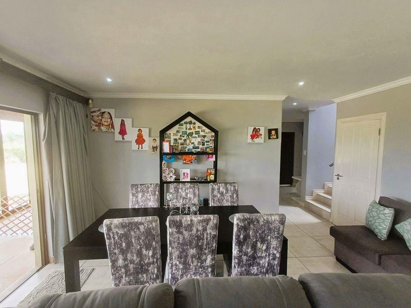 Open plan living and dining area featuring tiled flooring, recessed lighting, and direct access to an outdoor patio through sliding glass doors.