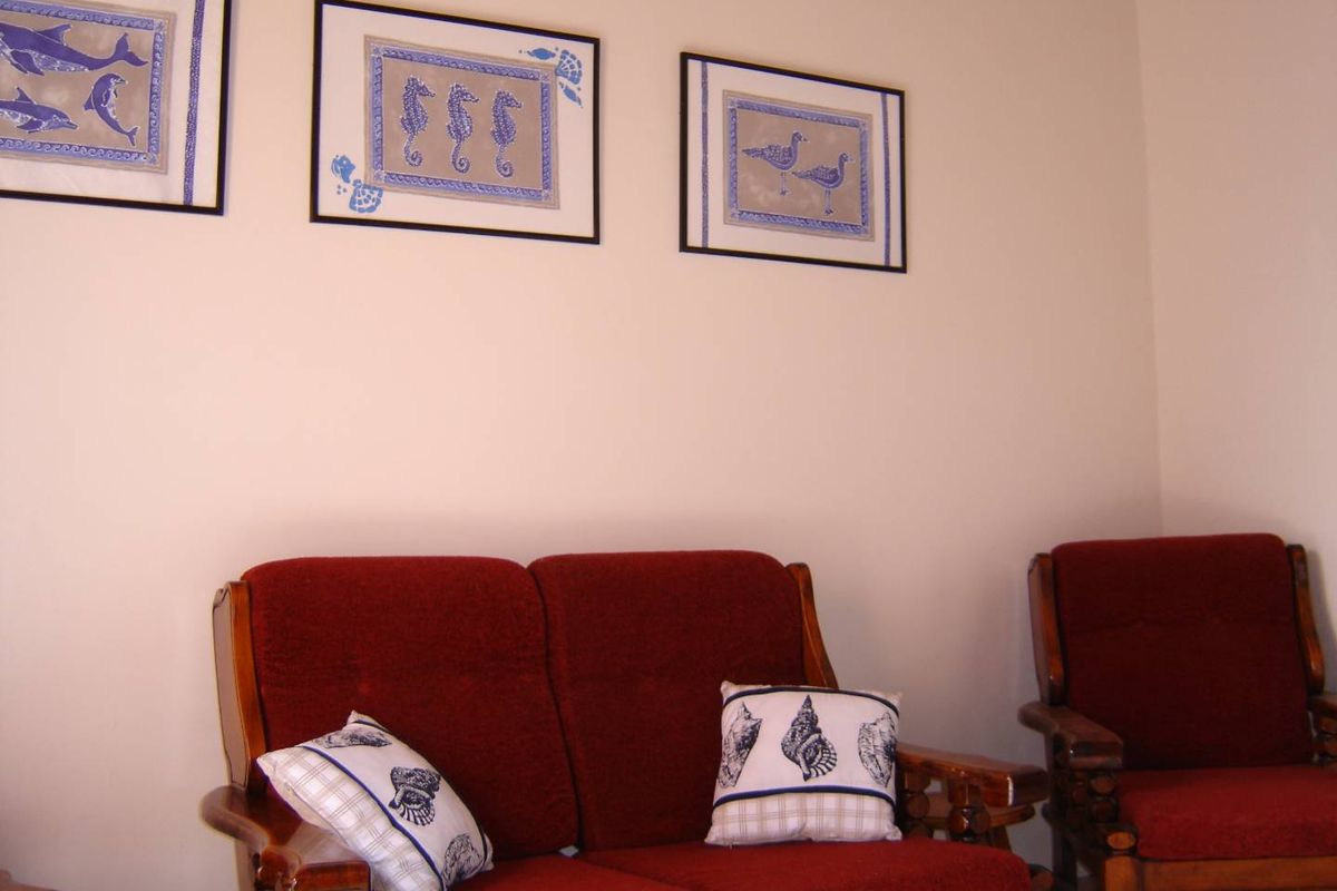 A view of a living room area featuring neutral wall finishes and space for seating.