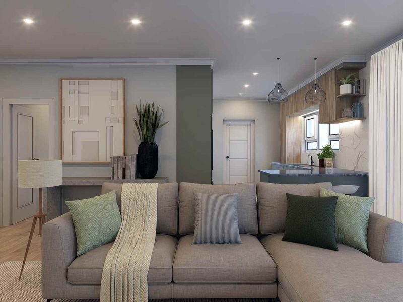 Modern open-plan living area featuring a contemporary kitchen with an island, recessed lighting, and neutral finishes throughout.