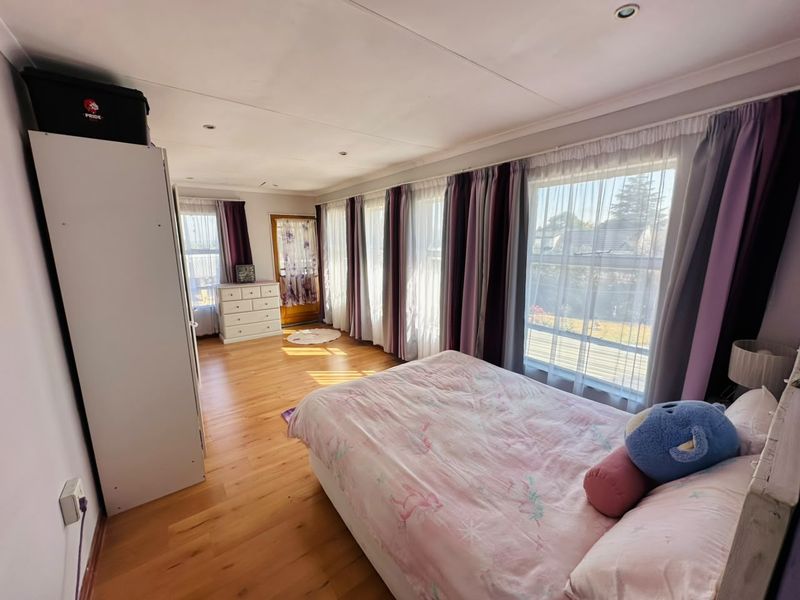 Spacious bedroom featuring hardwood flooring, recessed lighting, and large windows that provide ample natural light.