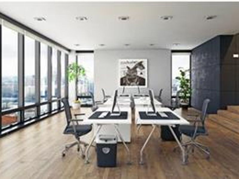 Modern open-plan office space featuring floor-to-ceiling windows, hardwood flooring, recessed lighting, and a raised platform area with a contemporary aesthetic.