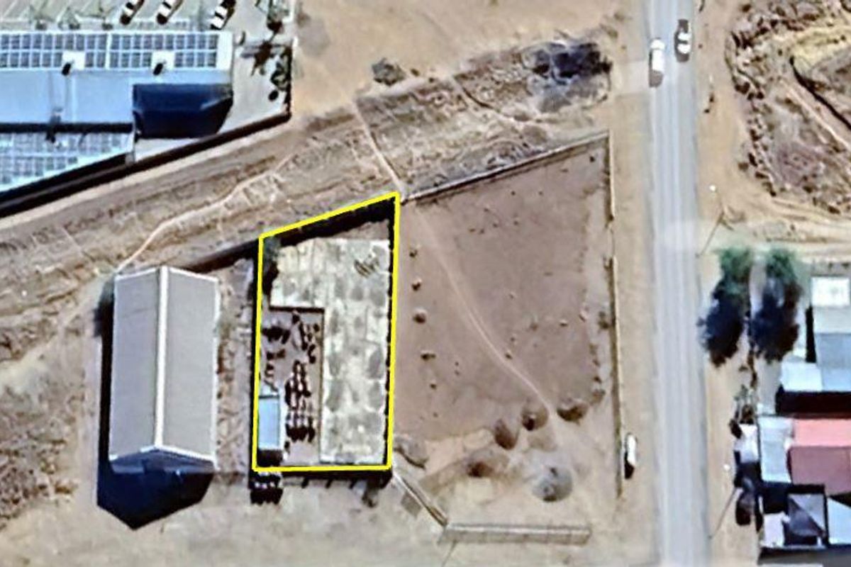 Aerial view of the property site showing the building footprint and surrounding land area.