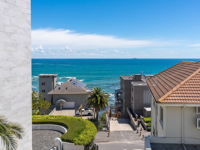 A clear elevated view overlooking the coastal neighborhood and the ocean.