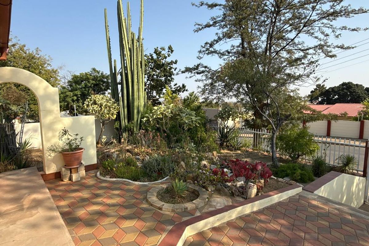 Set high above street level on a massive erf with a large front garden and elevated views - Photo 2